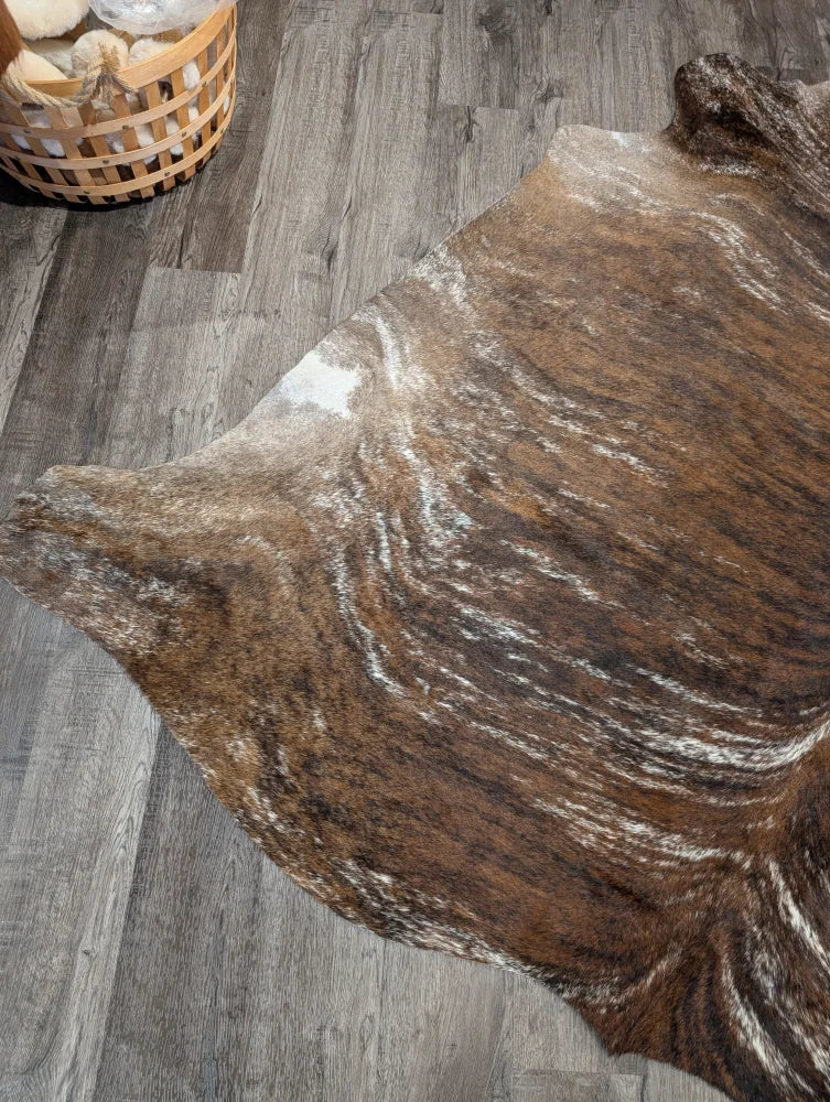 Tricolour 117 extra large cowhide rug with brown and white swirling patterns adds rustic charm and unique characteristics