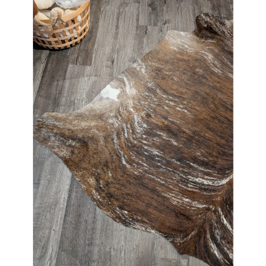 Tricolour 117 extra large cowhide rug with brown and white swirling patterns adds rustic charm and unique characteristics