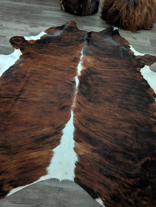 Brown and white tricolour16 extra large cowhide rug with natural fur texture measuring 86 by 82 inches