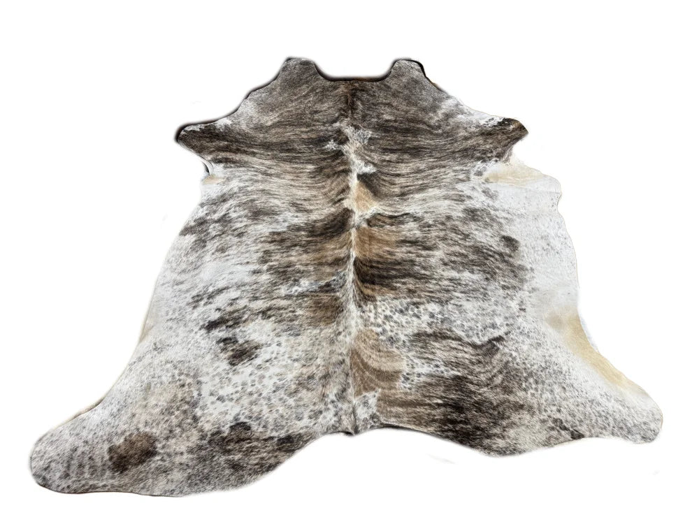 A large cowhide rug with unique characteristics featuring a beautiful tricolour white and dark gray speckled pattern