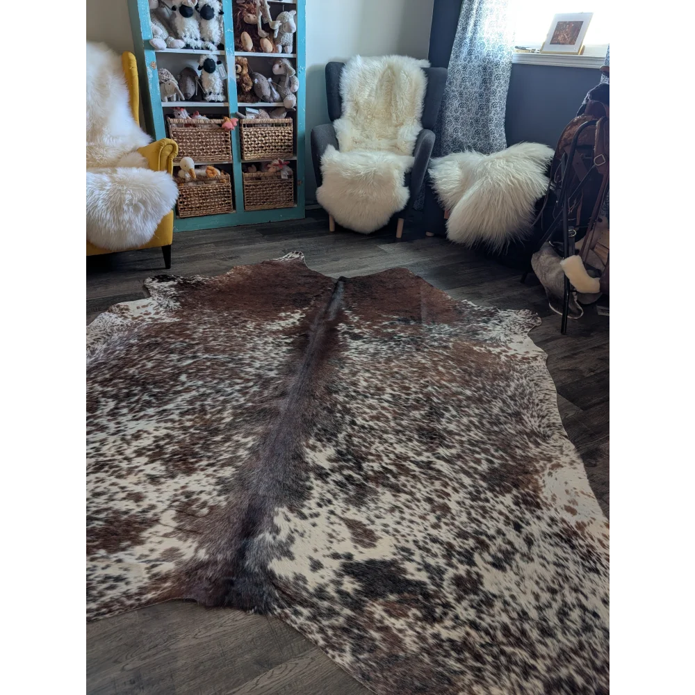 Brown and white spotted extra large cowhide rug with natural textured surface perfect for beautiful rugs collection