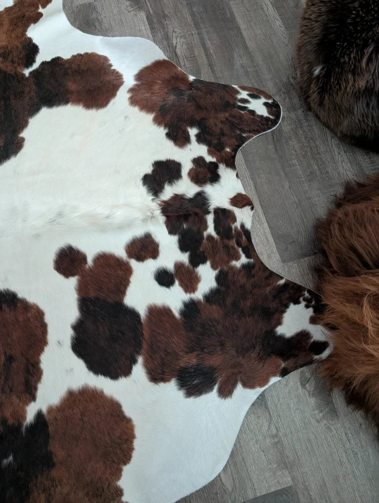 Tricolour#49 extra large cowhide rug with brown and black spots and a natural fluffy texture, measuring 96 by 82 inches