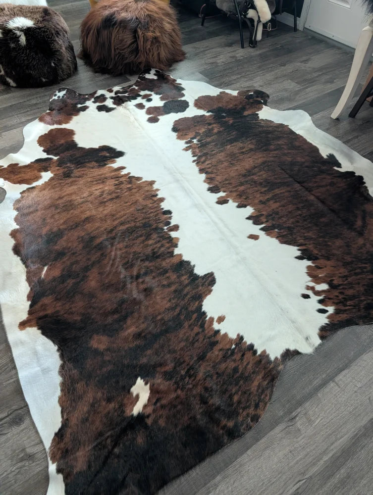 Extra large cowhide rug tricolour#49 with natural brown and white fur texture measuring 96 x 82 inches