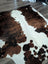 Brown and white extra large cowhide rug tricolour#49 with natural fur texture measuring 96 by 82 inches