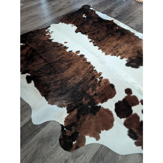 Brown and white extra large cowhide rug with natural fur texture perfect as a large cowhide floor decor