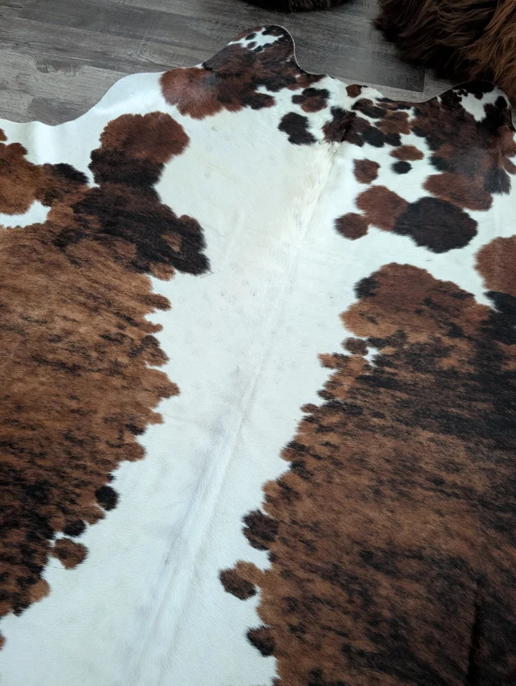 Brown and black spotted extra large cowhide rug tricolour49 with natural textured surface 96 by 82 inches