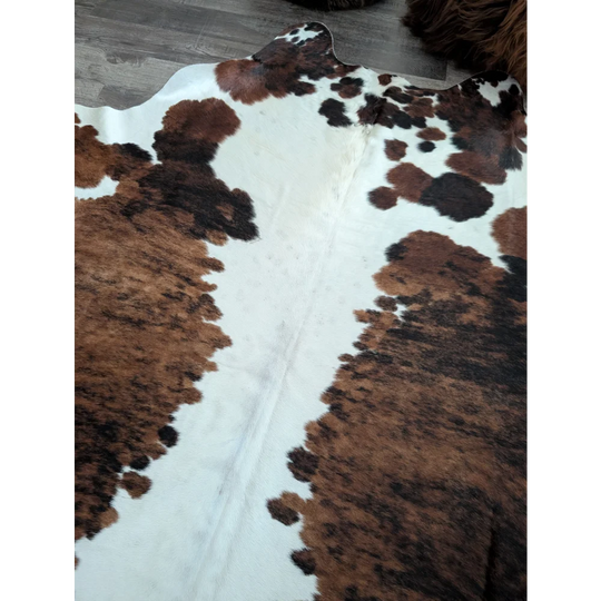 Brown and black spotted extra large cowhide rug tricolour49 with natural textured surface 96 by 82 inches