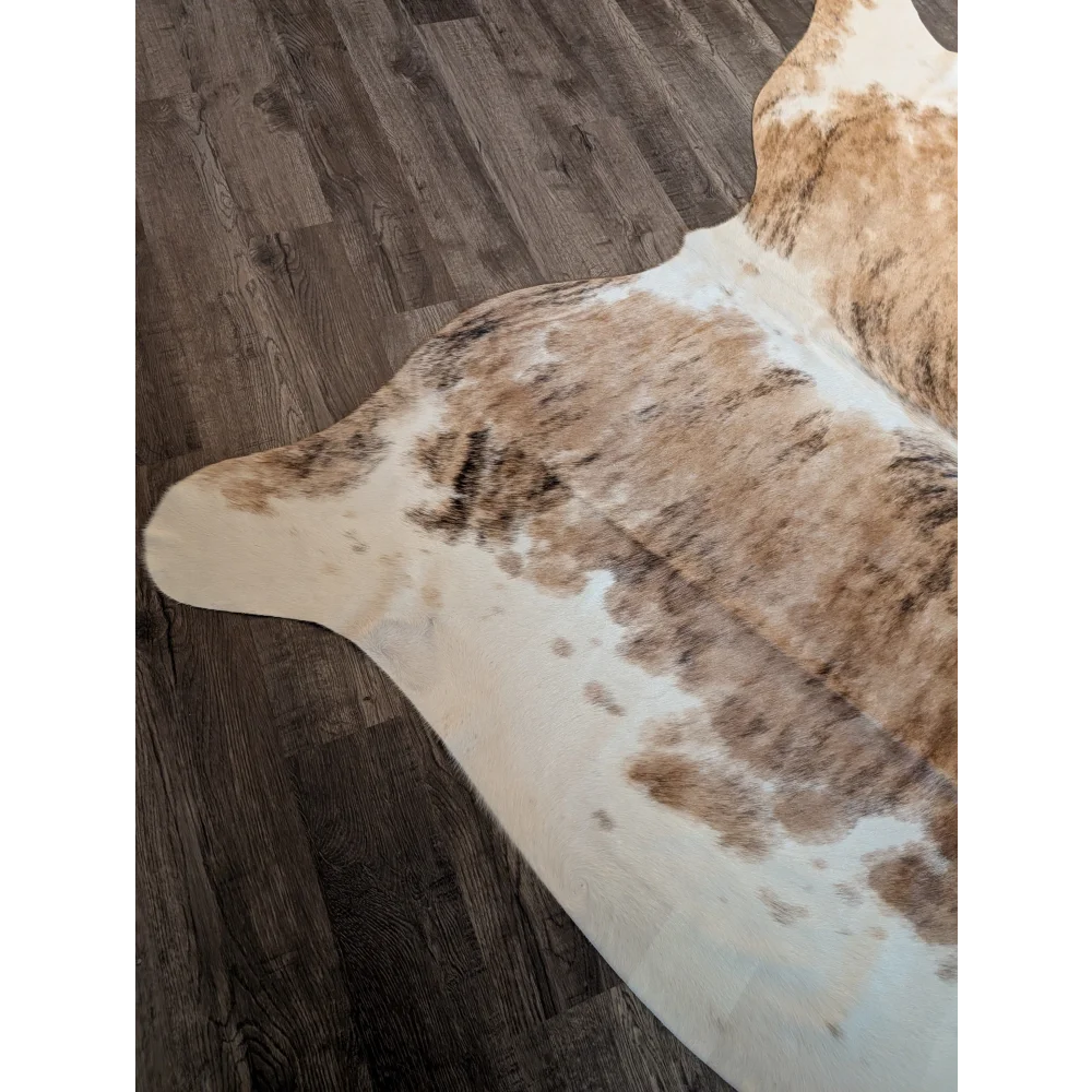 Extra large brown and white cowhide rug with natural irregular patches perfect as a large cowhide floor decor