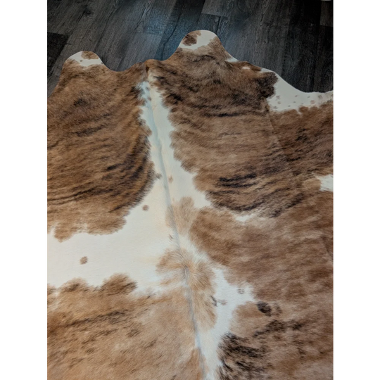 Brown and white extra large cowhide rug triColour553 with natural fur texture measuring 89 by 80 inches