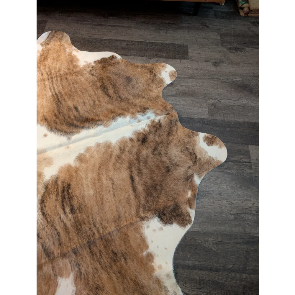Brown and white extra large cowhide rug with natural fur texture perfect for a large stylish floor covering