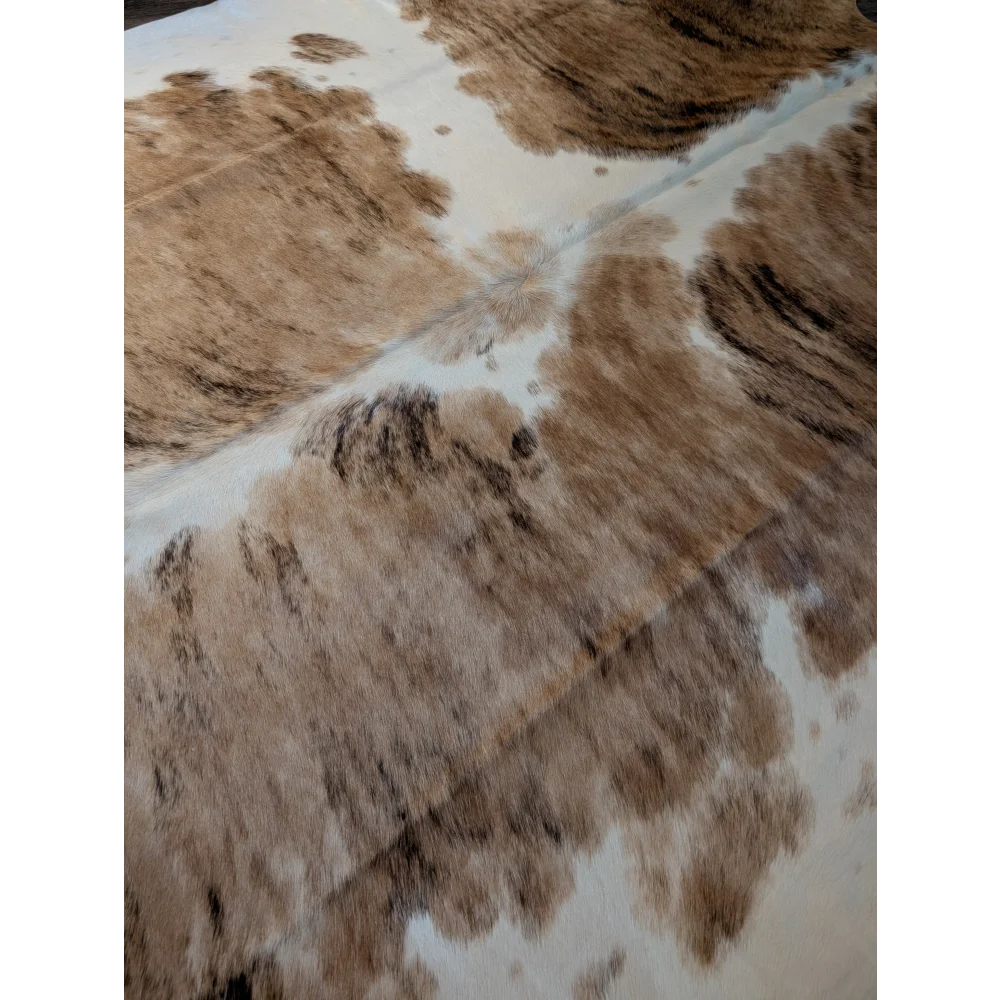 Extra large brown and white cowhide rug with natural fur texture perfect as a large cowhide floor decor