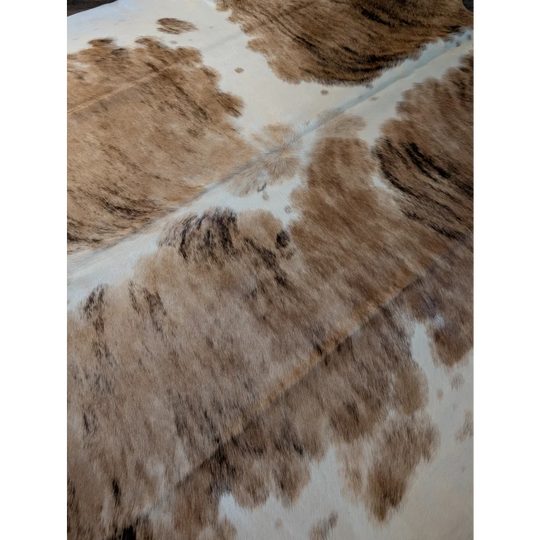 Extra large brown and white cowhide rug with natural fur texture perfect as a large cowhide floor decor