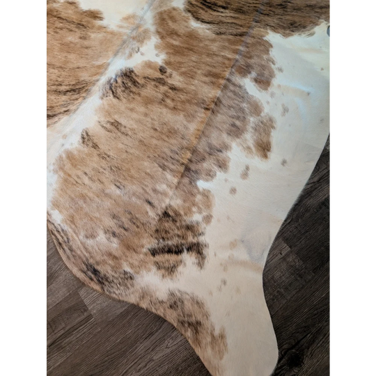 Brown and white extra large cowhide rug with natural fur texture perfect for a large cowhide decor statement