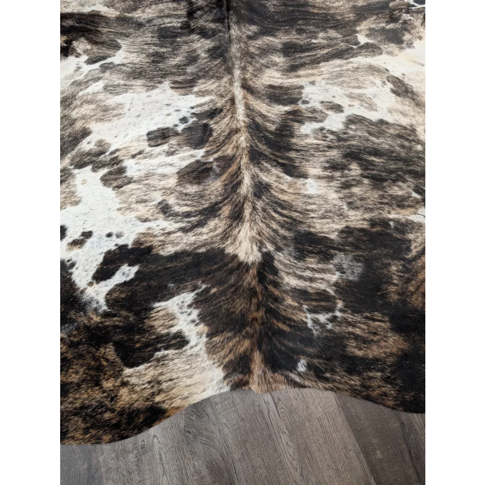Brown and white extra large cowhide rug with natural fur texture showing rustic charm and unique characteristics