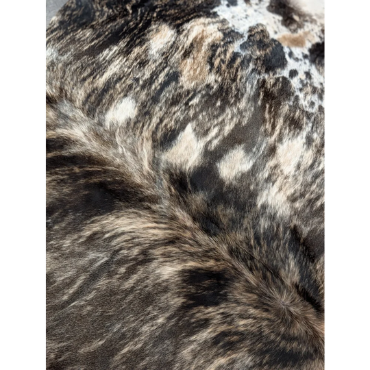 A plush extra large cowhide with natural black and white spotted pattern showing unique rustic charm