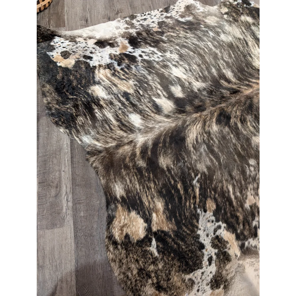 A gorgeous extra large cowhide rug with tricolour black white and tan patches offering rustic charm and unique characteristics