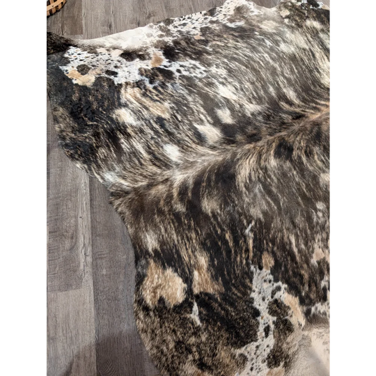A gorgeous extra large cowhide rug with tricolour black white and tan patches offering rustic charm and unique characteristics