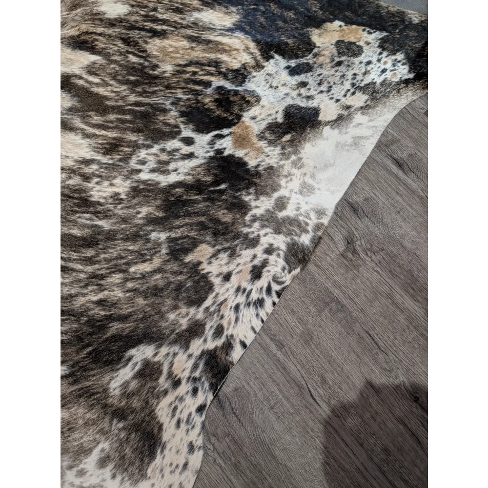 Tricolour 99 extra large cowhide rug with rustic charm features a textured mottled pattern in black white and tan patches