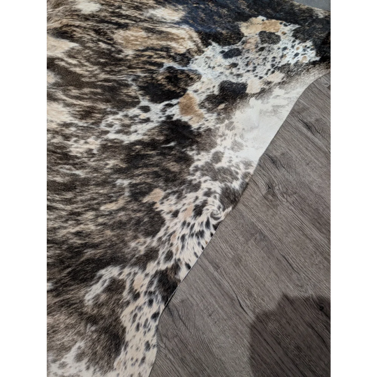 Tricolour 99 extra large cowhide rug with rustic charm features a textured mottled pattern in black white and tan patches