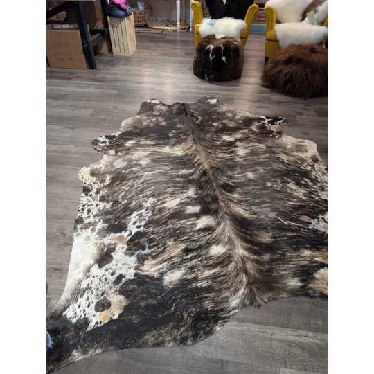 Tricolour 99 extra large cowhide rug with rustic charm features a unique black and white spotted pattern