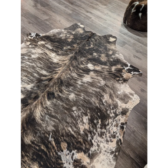 Tricolour 99 extra large cowhide rug with rustic charm and unique black white and tan mottled pattern