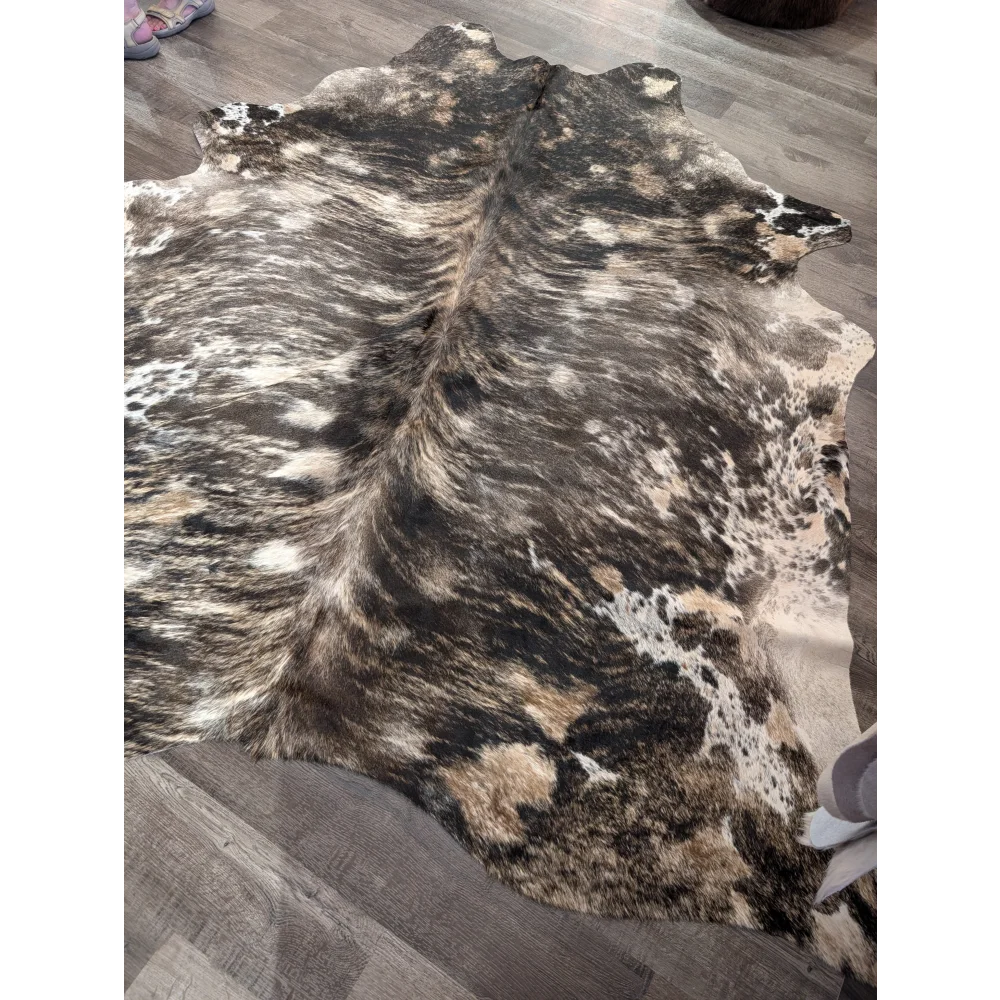 A natural extra large cowhide rug tricolour 99 with rustic charm and unique characteristics in black white and tan patches