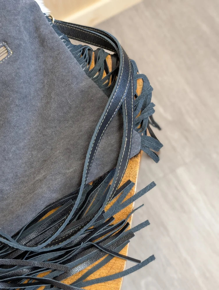 Denim-fringed tumbleweed 2 shoulder bag with smoky charcoal hand tooled patch and zippered pocket straps