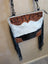 A stylish tumbleweed 2 crossbody bag with hand tooled brown leather floral embroidery smoky charcoal fur and zippered pocket