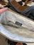 Cream lining with black dandelion pattern and myra label inside tumbleweed 2 tassel purse with zippered pocket and gold hardware