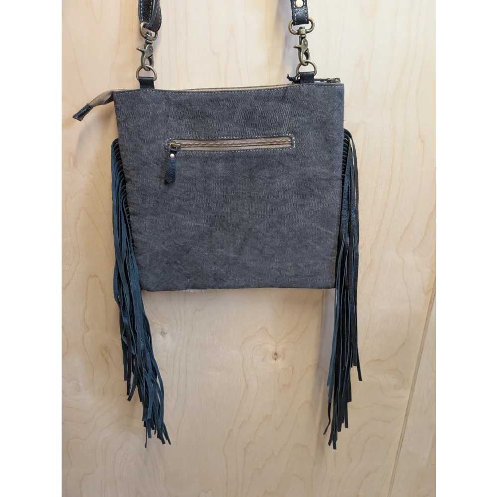 Dark gray suede tumbleweed 2 crossbody bag with smoky charcoal leather fringe and zippered pocket hand tooled details