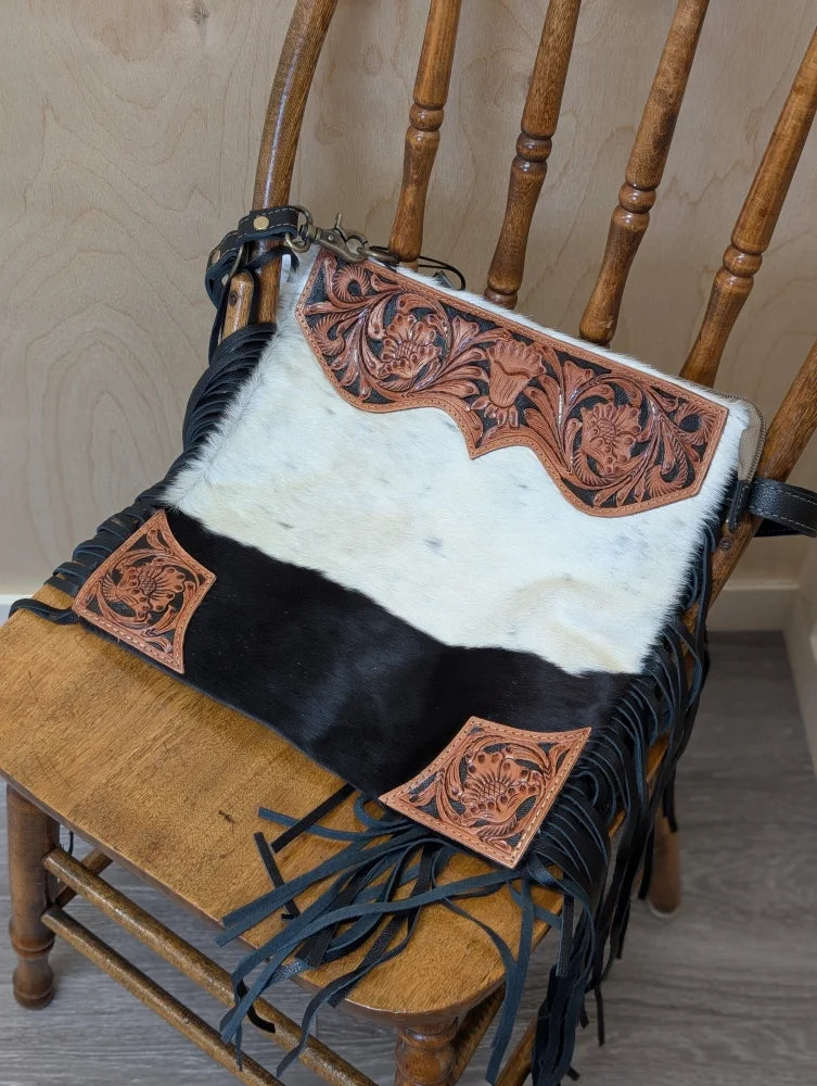 Tumbleweed #2 hand tooled black and white cowhide crossbody bag with smoky charcoal zippered pocket and fringed tassels
