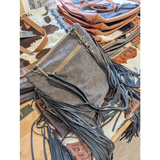 Gray denim crossbody bag tumbleweed 2 with black leather fringe brass hardware smoky charcoal hand tooled zippered pocket