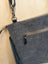 Gray denim crossbody bag tumbleweed 2 with black leather accents fringed detail and zippered pocket in smoky charcoal