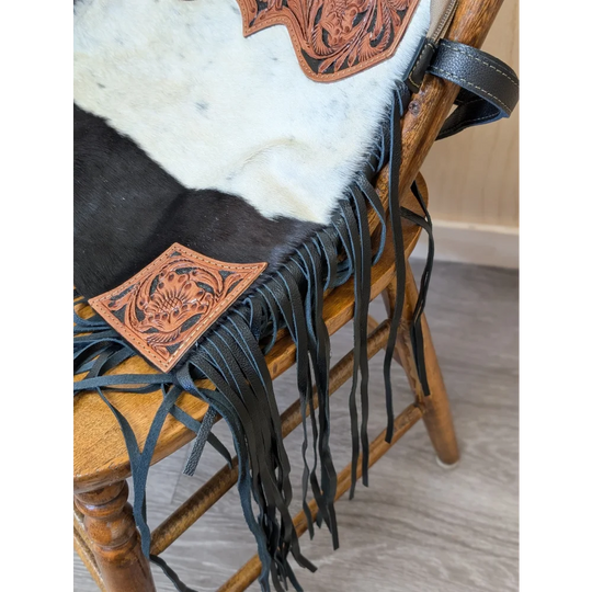 Tumbleweed 2 black and white cowhide fringe bag with hand tooled tan leather floral accents and zippered pocket