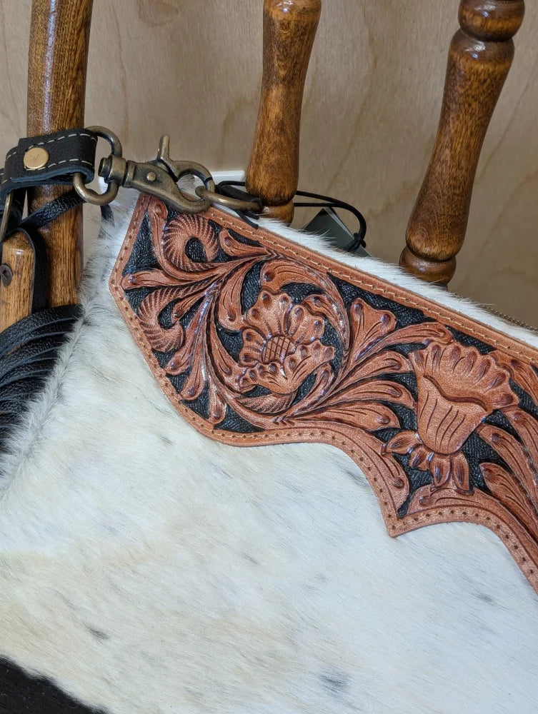 Brown leather strap with hand tooled floral design and metal clasp on tumbleweed 2 smoky charcoal tassel purse