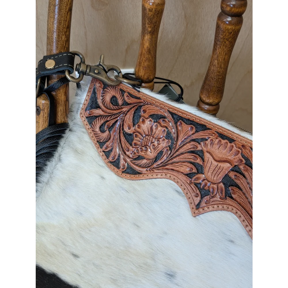 Brown leather strap with hand tooled floral design and metal clasp on tumbleweed 2 smoky charcoal tassel purse