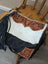 Tumbleweed 2 cowhide crossbody bag with smoky charcoal black and white fur, hand tooled tan leather, and zippered pocket