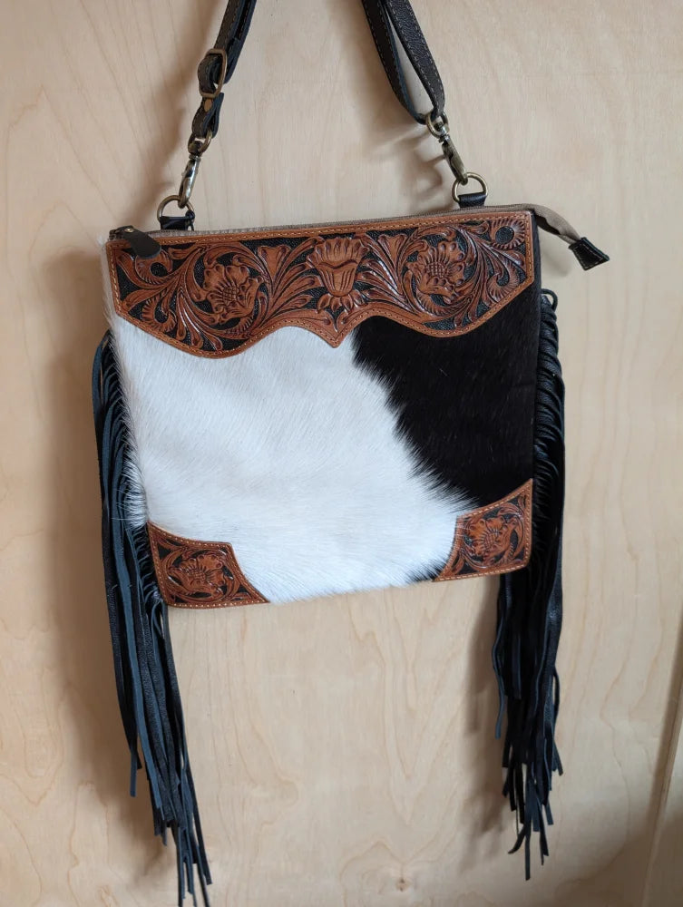 Tumbleweed 4 black and white cowhide crossbody bag with brown hand tooled floral embroidery smoky charcoal fringe and zippered pocket