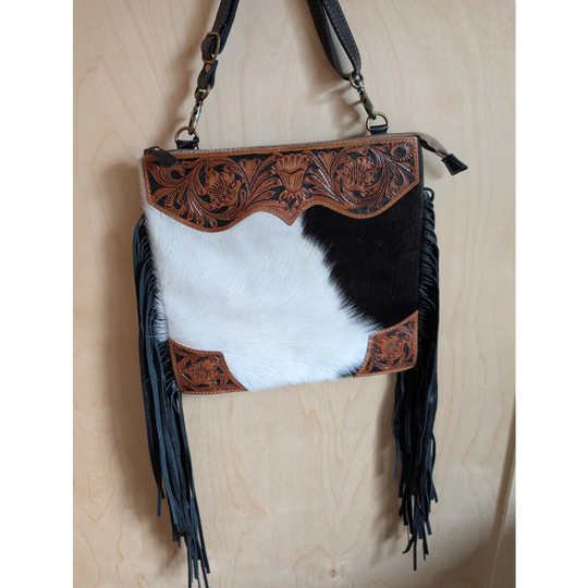 Tumbleweed 4 black and white cowhide crossbody bag with brown hand tooled floral embroidery smoky charcoal fringe and zippered pocket