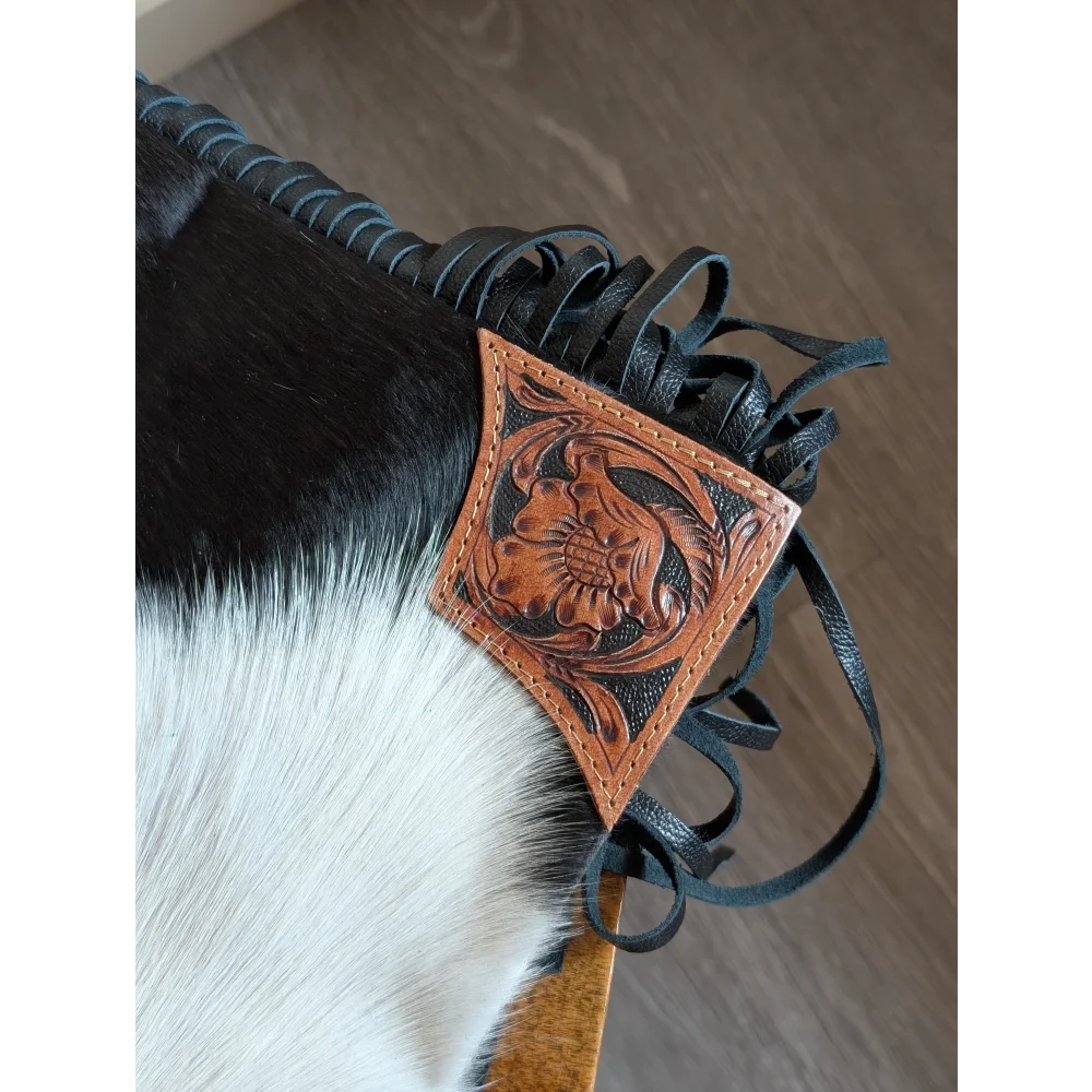 Tan leather hand tooled patch with floral design attached to black smoky charcoal fringed strap on tumbleweed 