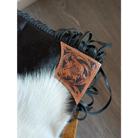 Tan leather hand tooled patch with floral design attached to black smoky charcoal fringed strap on tumbleweed 