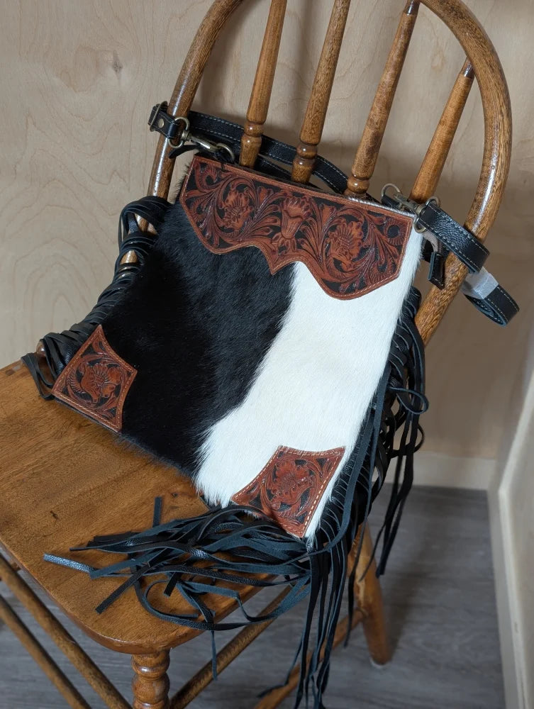 Tumbleweed #5 gorgeous tassel purse with black and white cowhide, hand tooled brown leather floral embroidery, and smoky charcoal fringe with zippered pocket