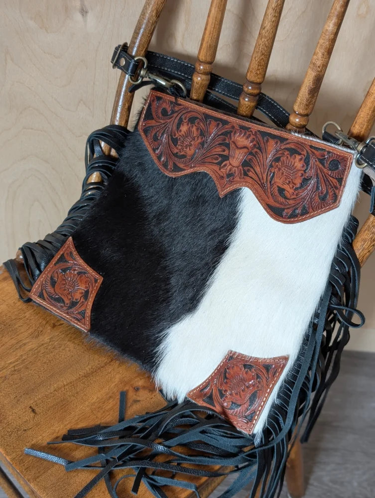 Tumbleweed #5 gorgeous tassel purse with black and white cowhide, hand tooled reddish brown leather, smoky charcoal fringe, and zippered pocket