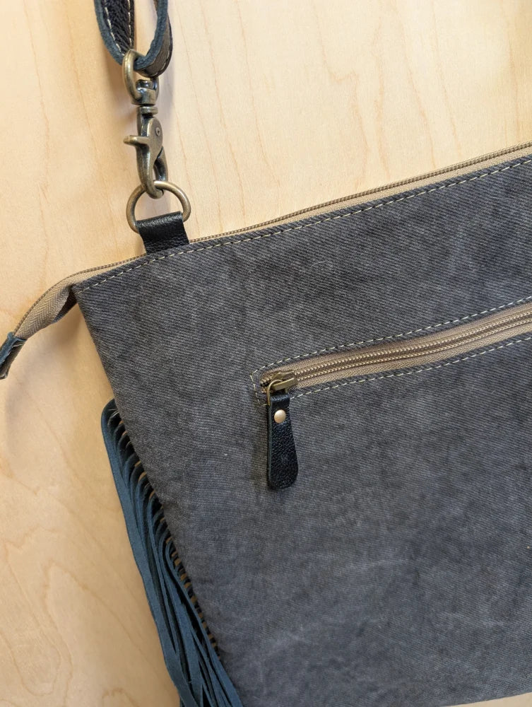 Gray denim crossbody bag tumbleweed 5 with black leather accents smoky charcoal fringe and zippered pocket hand tooled details