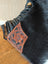 Tumbleweed 5 gorgeous tassel purse with hand tooled brown leather patch and black stitched edges on smoky charcoal boot