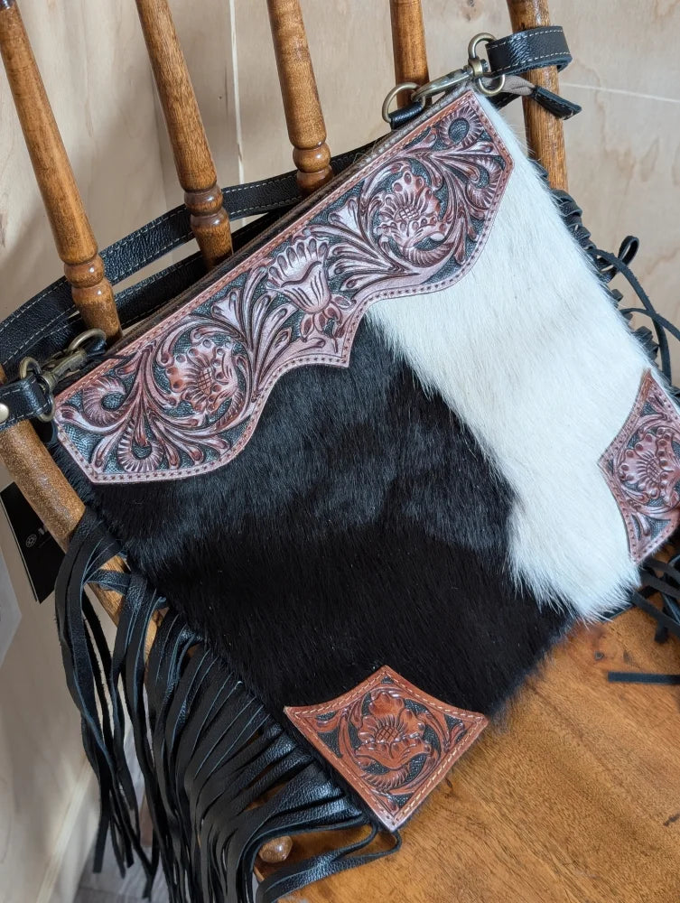 Tumbleweed 5 black and white cowhide crossbody bag with hand tooled pink floral embroidery and smoky charcoal fringe