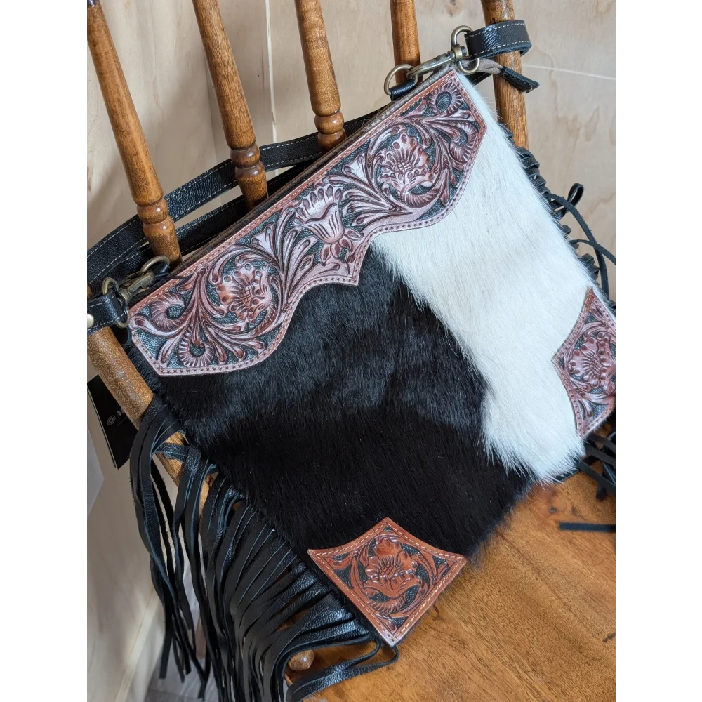 Tumbleweed 5 black and white cowhide crossbody bag with hand tooled pink floral embroidery and smoky charcoal fringe