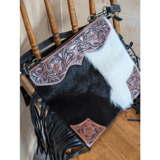 Tumbleweed 5 black and white cowhide crossbody bag with hand tooled pink floral embroidery and smoky charcoal fringe