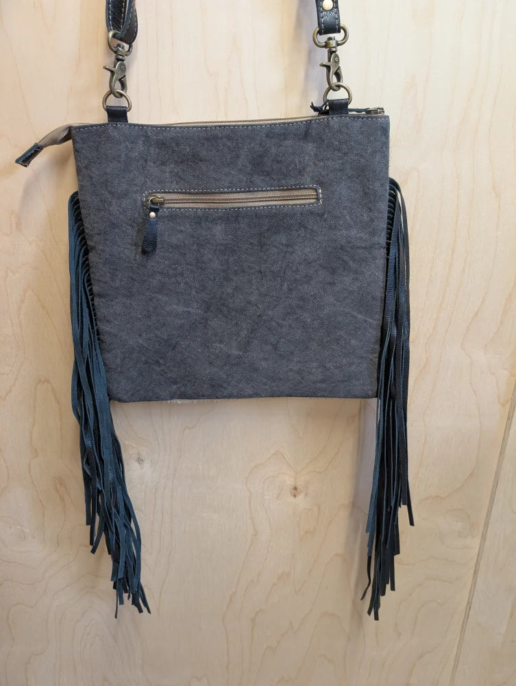 Dark gray suede tumbleweed #5 crossbody bag with black leather fringe metal hardware and zippered pocket in smoky charcoal