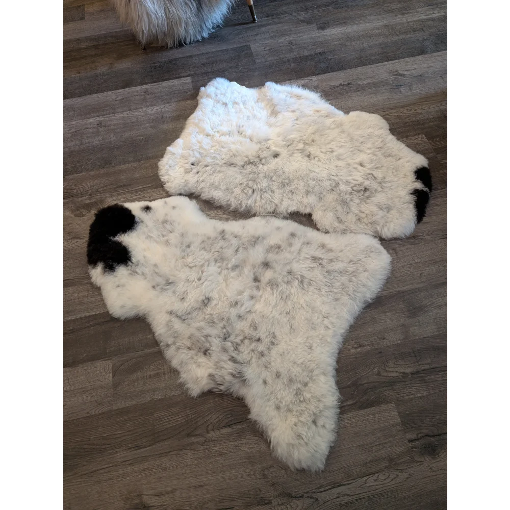 Two icelandic sheepskins with white short wool and black-tipped ends natural fur texture spot 8 and 9